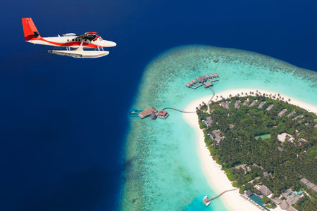Sea plane flying above Maldives islands, Raa atol