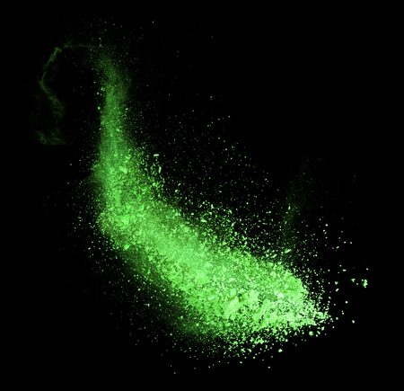 Explosion of green powder, isolated on black backgroundの写真素材