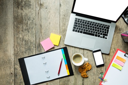 Laptop with other modern electonic devices placed on wooden desk. Concept of modern technology and hipster office interior. high angel view.の写真素材