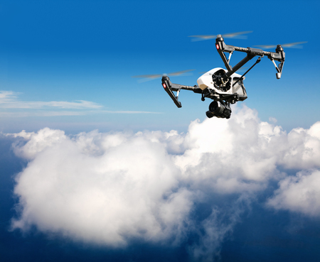 Drone for industrial works flying above clouds. Concept of pottential danger of aircraft collisionの写真素材