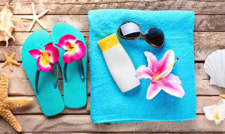 Beach accessories on wooden background, copyspace for text