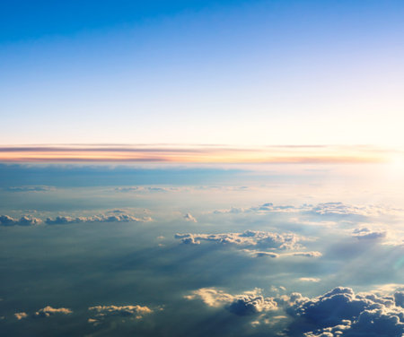 Beautiful sunset above clouds from airplane perspective