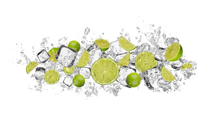 Pieces of limes in water splash and ice cubes, isolated on white backgroundの写真素材