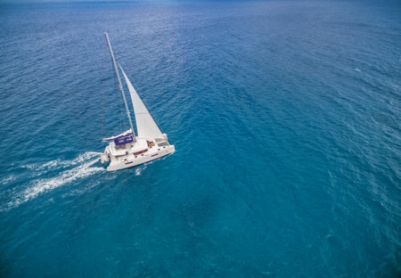 Aerial view of catamaran sailling in ocean open water