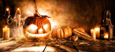 Scary halloween pumpkin on wooden planks. Empty space for textの写真素材
