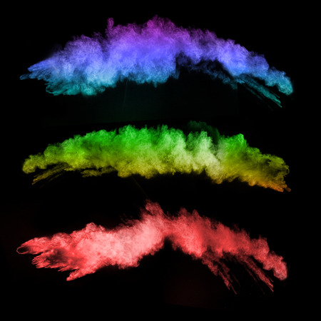 Explosion of colored powders, isolated on black backgroundの写真素材