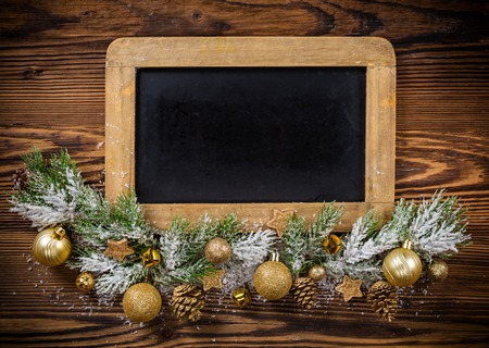 Christmas decoration with empty blackboard placed on wooden planks. Copyspace for textの写真素材