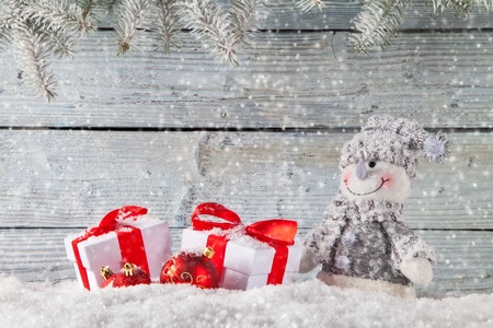 Handmade snowman and christmas decoration on wooden background. Copyspace for textの写真素材