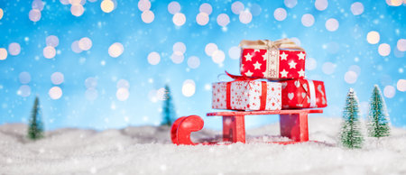 Christmas background with pile of gifts placed on red sledge