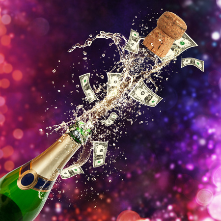 Splashing bottle of champagne with dollars currency. Celebration and success concept, free space for textの写真素材