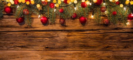 Christmas garland decoration placed on wooden planks. Copyspace for textの写真素材