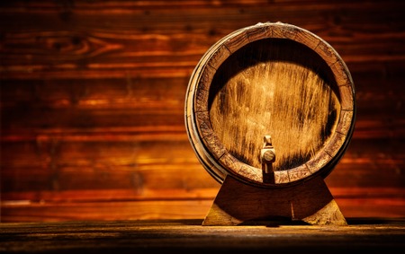 Wooden round barrel with old planks on background, copyspace for textの写真素材