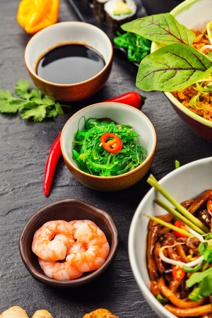 Asian food served on black stone. Chinese and vietnamese cuisine set.の写真素材