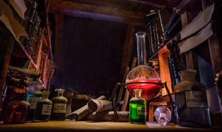 Medieval alchemist laboratory with various kind of flasks and old books in Prague, czech republicの写真素材