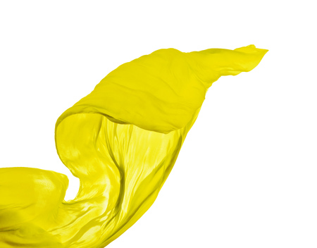 Smooth elegant yellow transparent cloth separated on white background. Texture of flying fabric.の写真素材