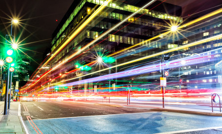 Blur traffic lights in modern city, long exposure. Fast cars created colored lines of light