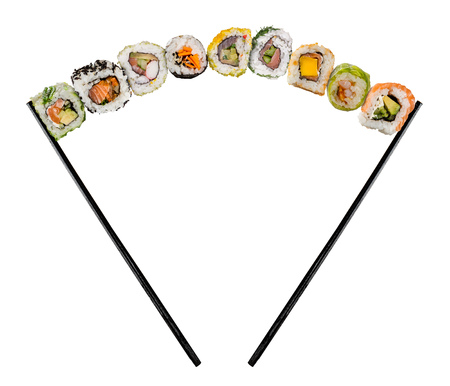 Sushi pieces placed between chopsticks, separated on colored background. Popular sushi food.の写真素材