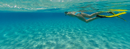 Snorkeling woman exploring beautiful ocean sealife, underwater photography. Travel lifestyle, water sport outdoor activities, swimming and snorkeling on summer beach holidays.の写真素材