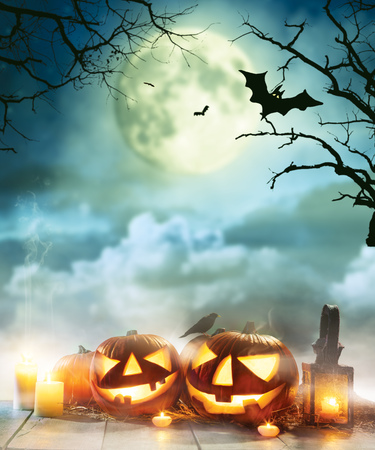Spooky halloween pumpkins on wooden planks with dark horror background. Celebration theme, copyspace for text. Very high resolution imageの写真素材