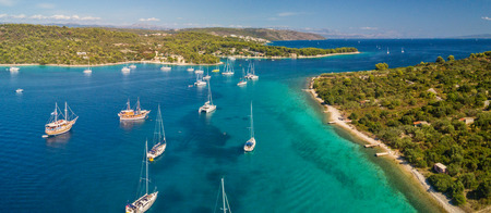 Aerial view of group of sailing boats anchoring on buoys. Bird eye view, water sport theme.の写真素材