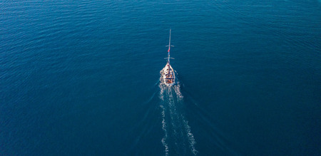 Aerial view of sailing boat on open sea. Bird eye view, water sport and relaxの写真素材