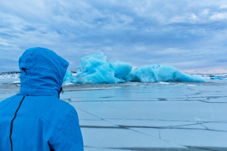 Man explorer in Fjallsarlon iceberg, Iceland. Polar explorer, travel and hiking conceptの写真素材