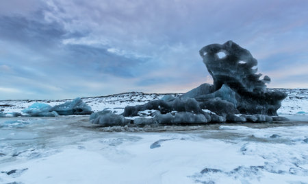 Iceberg lagoon in Fjallsarlon, Iceland. Beautiful sunset light, concept of global warming and ice...