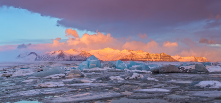 Iceberg lagoon in Fjallsarlon, Iceland. Panoramic view of beautiful sunset light, concept of global warming and ice melting.の写真素材