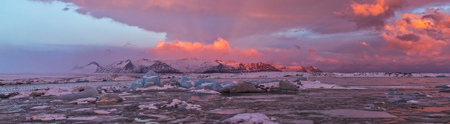 Iceberg lagoon in Fjallsarlon, Iceland. Panoramic view of beautiful sunset light, concept of global warming and ice melting.の写真素材