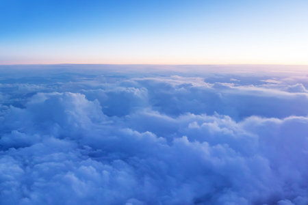 Beautiful sunset panoramic view above clouds. Airplane view