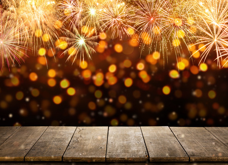 Celebration background with fireworks explosions and empty wooden planks, ideal for product placementの写真素材
