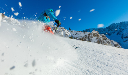 Young man freerider skiing downhill in Alps. Beautiful clear blue sky. Winter sports and recreation.の写真素材