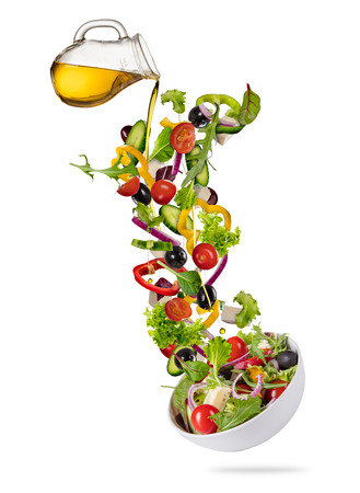 Flying vegetable greek salad isolated on white background. Healthy eating and lifestyle. Very high resolution imageの写真素材