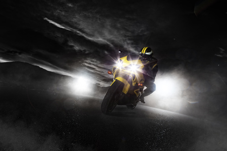 Supersport motorcycle driver at night with smoke around.の写真素材