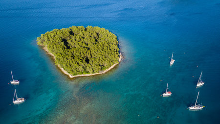 Aerial view of sailing boats anchoring next to small island, Croatia. Active life style, water...