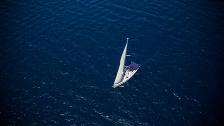 Sailing boat on open water, aerial view. Active life style, water transportation and marine sport.
