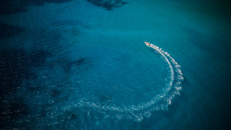 Aerial view of speed boat in motion. Water transportation and summer leisure time activity.の写真素材