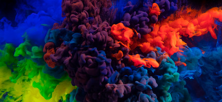 Mix of coloured inks in water on black background. Abstract colored backgroundの写真素材