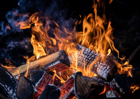 Burning wooden logs in fire, campfire isolated on black background