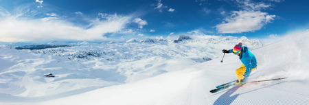 Alpine skier skiing downhill, panoramic format. Winter sports and leasure activitiesの写真素材