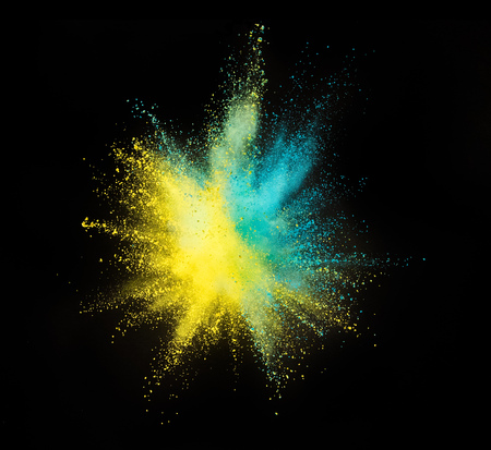Explosion of colored powder isolated on black background. Abstract colored backgroundの写真素材