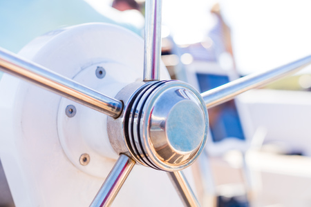 Detail of modern sailing yacht steering wheel. Leasure activities and extreme sport. Low depth of focus.の写真素材