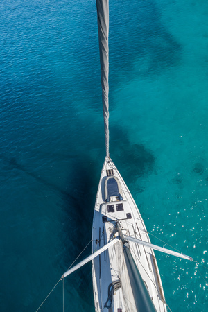 Top view of sailing boat anchored in the shallows. Summer sport and recreation activities.の写真素材