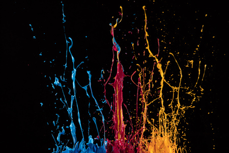 Macro photo of mixed acryl colors isolated on black background. Abstract coloured background.の写真素材