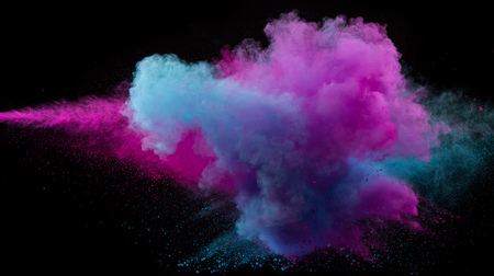 Collision of two colored powders isolated on black background. Abstract colored backgroundの写真素材