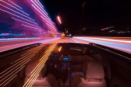 POV of car driving at night city with motion blur effect. Transportation and traffic concept