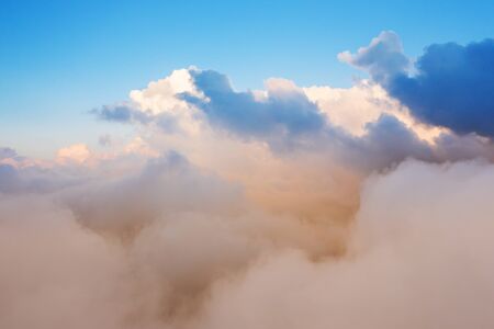 Beautiful sunset cloudy sky from aerial view. Airplane view above cloudsの写真素材
