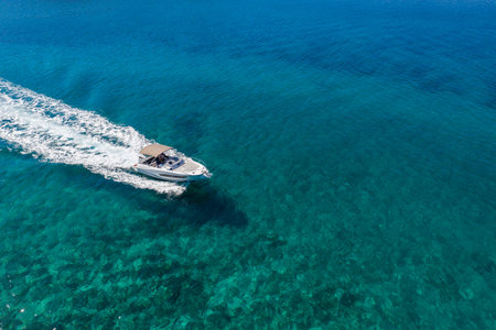 Aerial view of speed motor boat in shallow water.