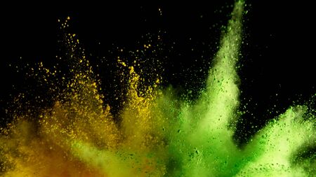 Explosion of colored powder isolated on black background. Abstract colored backgroundの写真素材