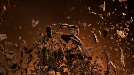 Flying pieces of crushed chocolate pieces, delicious fresh dark brown chocolate fragments.の写真素材